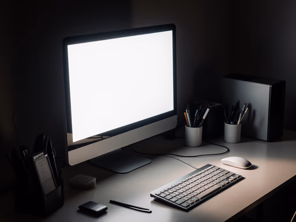 desk_with_uneven_lighting_showing_glare_on_monitor_and_dark_corners